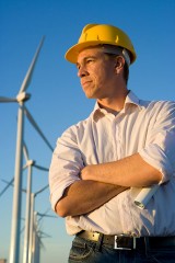an electrical engineer, with windmills in the background